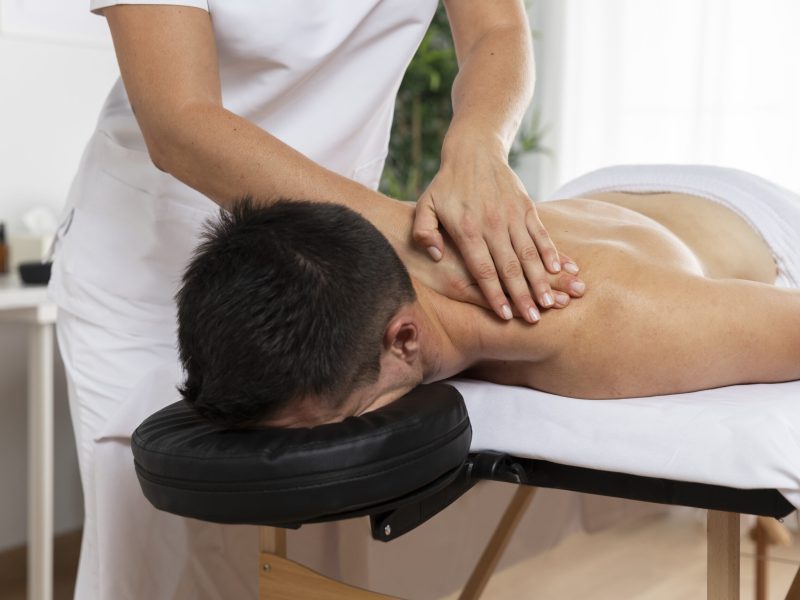 physiotherapist-massaging-patient-office