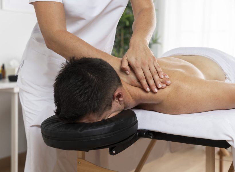 physiotherapist-massaging-patient-office